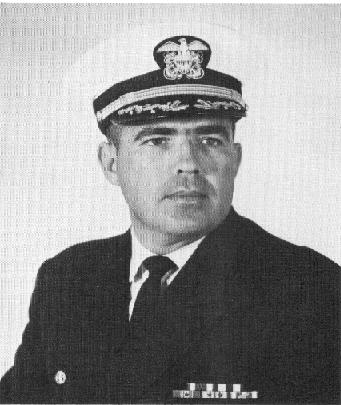 Captain wearing dark jacket with medals and a captains hat