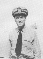 Captain wearing captains hat and button up standing on a boat